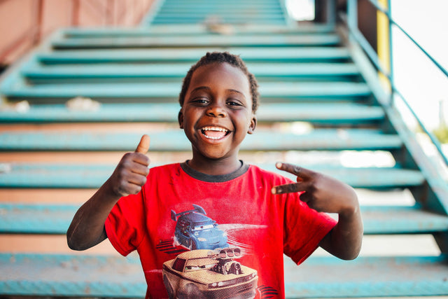 Photo by Tetbirt Salim A person experiencing a moment of genuine laughter and somatic joy, representing the Mayowa Samuel philosophy of unburdening adulthood through wellness.